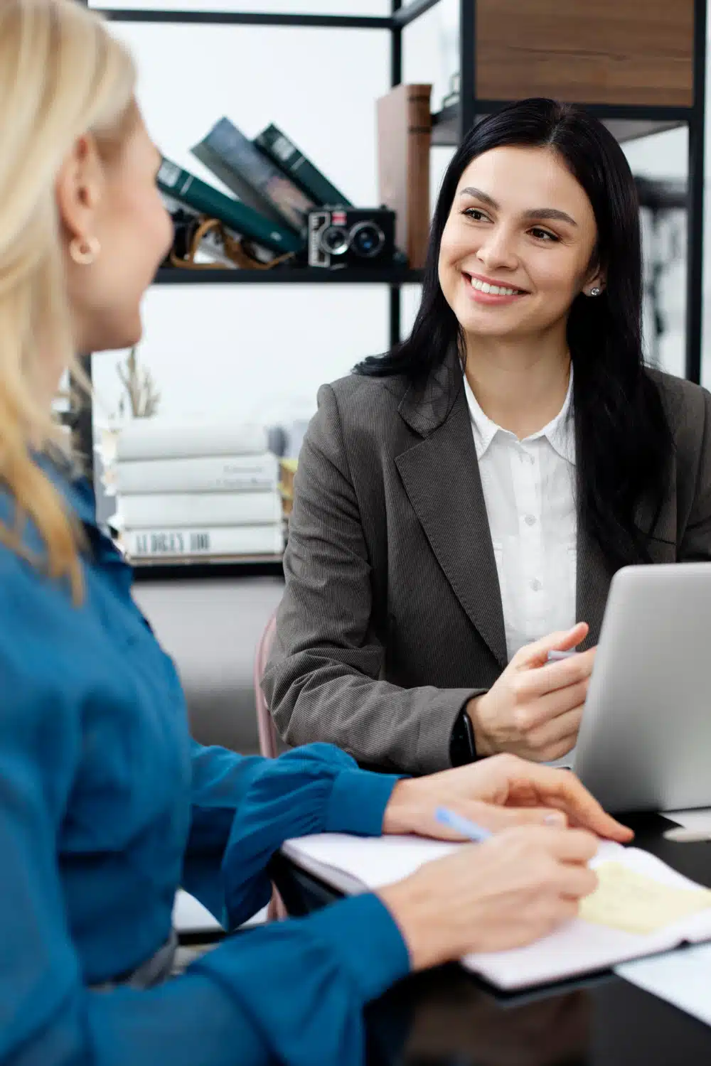 Smiling attorney offering a free consultation to a client in a bright office setting